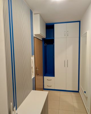 Předsíň, u které na první pohled zaujme kontrastní modrý dekor. Návrh a výroba podle specifického přání majitelky bytu....